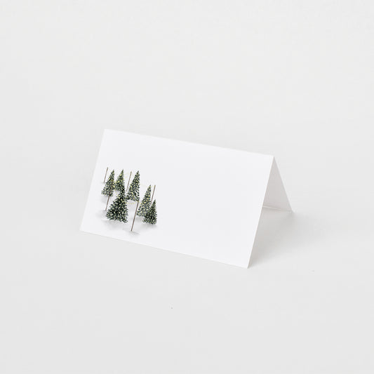 Holiday folded place card set of 12 featuring a watercolor Christmas tree stand illustration.