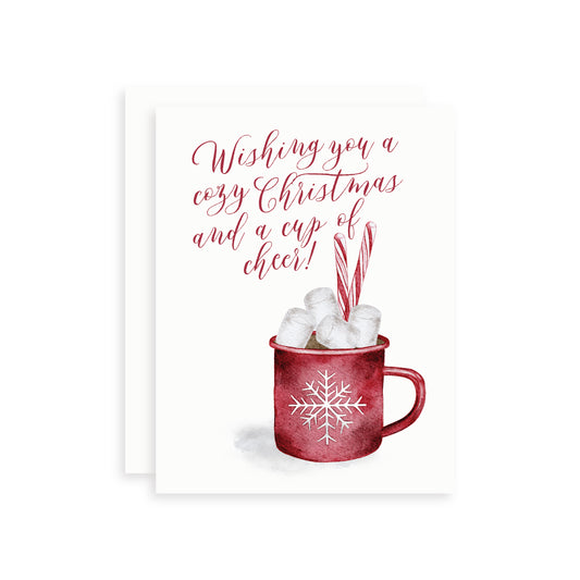 Holiday card with a watercolor illustration of a red mug of hot chocolate, marshmallows, and candy canes with text 'Wishing you a cozy Christmas and a cup of cheer!'.