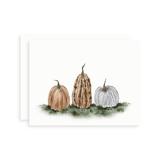 Fall watercolor card of three pumpkins in different fall colors on a white background