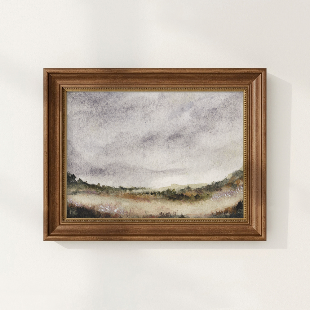 Framed landscape painting on a white wall