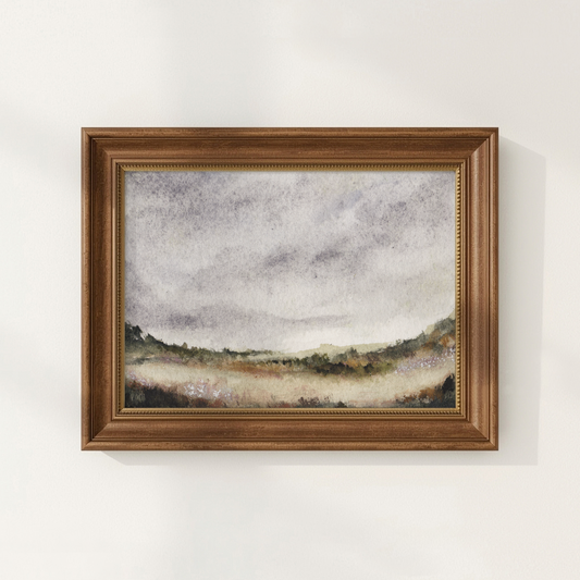 Framed landscape painting on a white wall