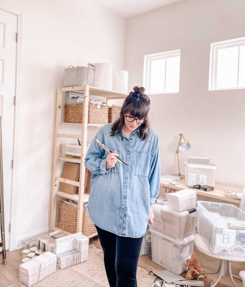 Raechelle Marie, fine artist and shop owner, standing in her studio