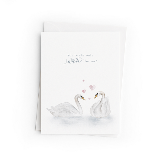 Greeting card with two swans and hearts on a white background